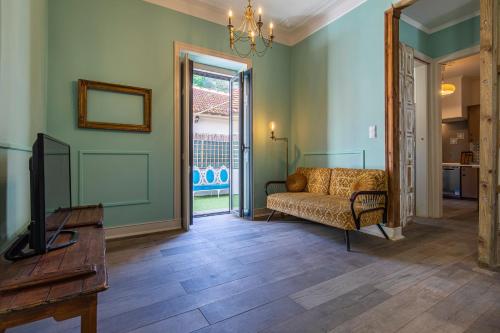 a living room with a couch and a tv at Classic Villa in Beato Lisbon in Lisbon