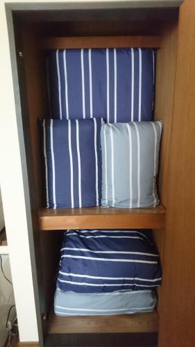 two pillows sitting on a shelf in a cabinet at アルピエa敷地内無料駐車場付き in Kumamoto