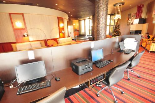 an office with a desk with two computers and a printer at Radisson Hotel Duluth-Harborview in Duluth
