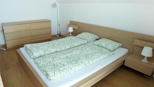 a bedroom with a bed with a wooden headboard at Penzion Emilia in Ružomberok