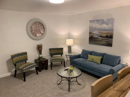 a living room with a blue couch and chairs at Stylish 2BD/1BA apartment located in Federal Hill in Baltimore