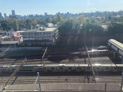 a train on the tracks at a train station at APA Hotel TKP Nippori Ekimae in Tokyo