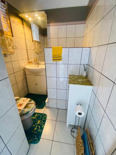 a bathroom with a toilet and a sink at SERENITY piscine 53m cube in La Trinité