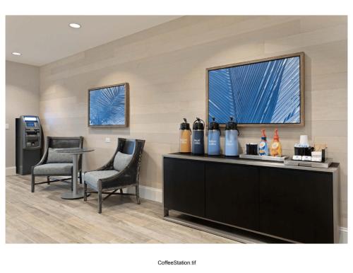 a waiting room with two chairs and a table and a window at Homewood Suites By Hilton Panama City Beach, Fl in Panama City Beach