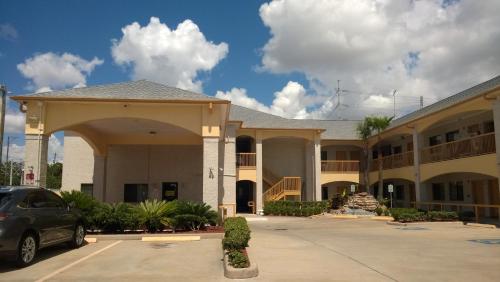 a parking lot in front of a hotel at Scott Inn & Suites - Downtown Houston in Houston