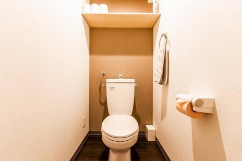 a bathroom with a toilet in a small room at SWEET in Sapporo