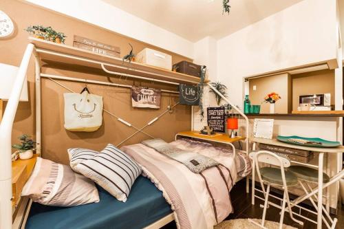 a room with a bunk bed and a desk at SWEET in Sapporo