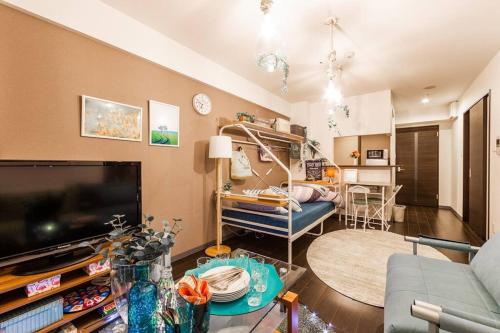 a living room with a large flat screen tv at SWEET in Sapporo