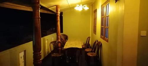 a bathroom with a table and a group of chairs at Narra Homestay in Maskeliya