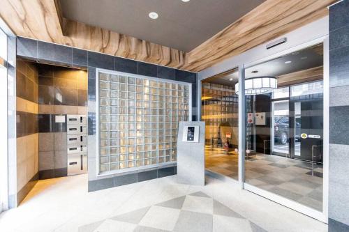 a lobby with a glass door and a building at EDEN in Sapporo