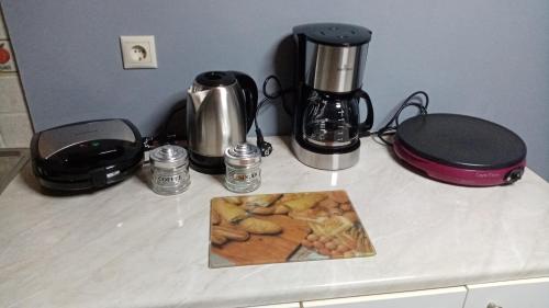 a counter top with two appliances and a picture on it at CASA THEOTOKI in Anemómylos
