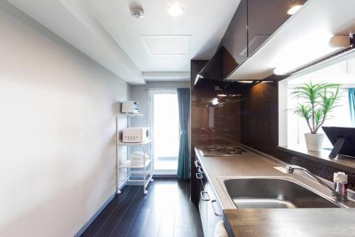 a kitchen with a sink and a counter top at STARDUST in Sapporo