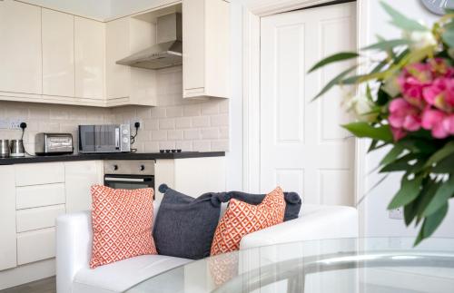 a living room with a couch and a glass table at Ipswich Town Centre - Apartment 7 in Ipswich