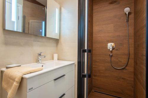 a bathroom with a sink and a shower at Apartments Mandre I in Mandre