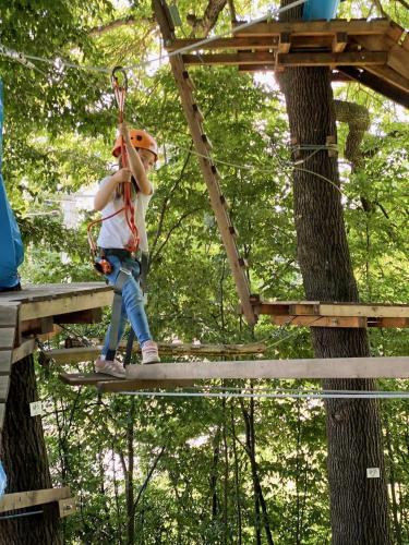 a young girl is sitting on a tree house at APARTMENT WALD - im Skigebiet Gerlitzen & Ossiacher See in Bodensdorf