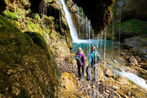 two people walking in front of a waterfall at APARTMENT WALD - im Skigebiet Gerlitzen & Ossiacher See in Bodensdorf