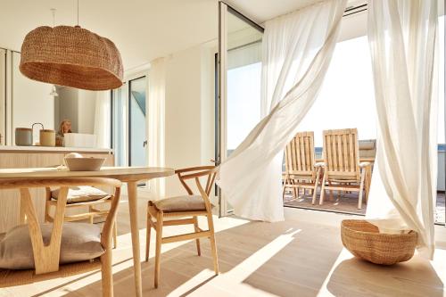 a kitchen and dining room with a table and chairs at Inselhouse in Norderney