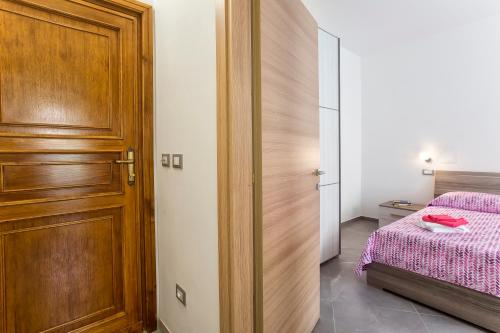 Ένα ή περισσότερα κρεβάτια σε δωμάτιο στο Nonna Adelina Apartments & rooms