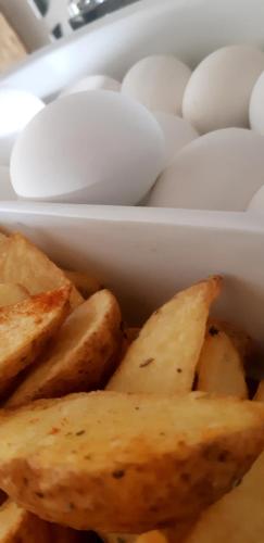 a white container filled with eggs and potatoes at Hotel Monec in Ankara