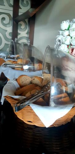 a basket filled with bread and tongs on a table at Hotel Monec in Ankara