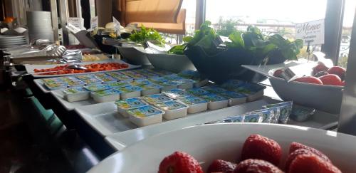 a buffet of food with strawberries and other foods at Hotel Monec in Ankara