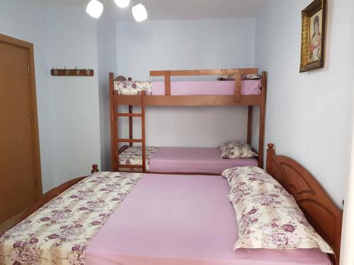a bedroom with two bunk beds in a room at Comfortable apartment in Shëngjin