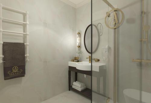 a white bathroom with a sink and a shower at Arkadia in Radziejów