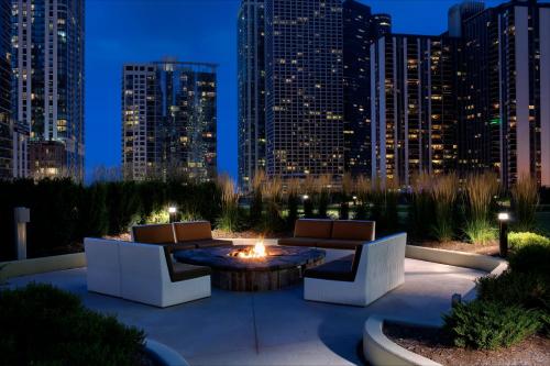 a patio with couches and a fire pit with a city skyline at Radisson Blu Aqua Hotel, Chicago in Chicago