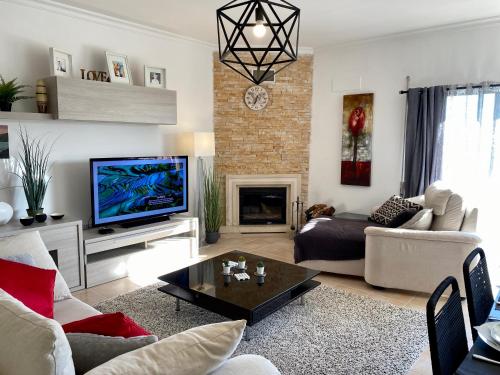 a living room with a couch and a tv at Blue Sky apartment Marina in Lagos