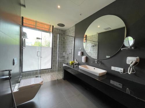 a bathroom with a sink and a mirror at Flora Vythiri Resort in Vythiri