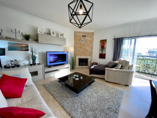 a living room with a couch and a tv at Blue Sky apartment Marina in Lagos