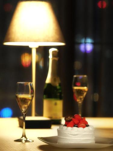 a table with two glasses of wine and a bottle of champagne at Hotel Royal Classic Osaka in Osaka