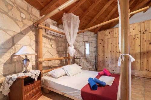 a bedroom with a bed in a stone room at Gerakomylos Stone House in Vasilikos