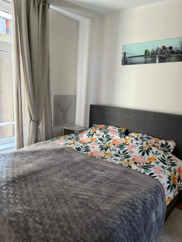 a bedroom with a bed with a colorful blanket at Cosy appartement with canal view in Brussels
