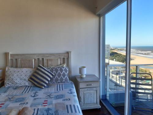 a bedroom with a bed and a view of the beach at Granada Penthouse 1 in Margate