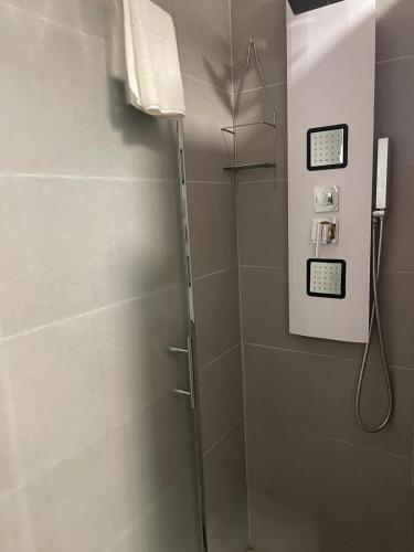 a shower stall in a bathroom with a phone at Evergreen in Polignano a Mare