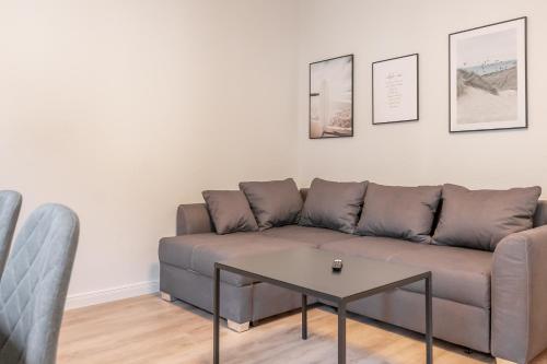 a living room with a couch and a table at Landschaftliches Haus in Tönning