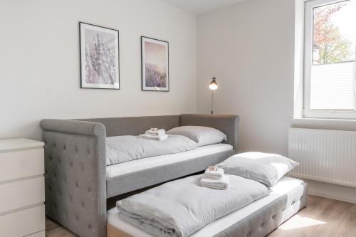 a room with two beds with towels on them at Landschaftliches Haus in Tönning