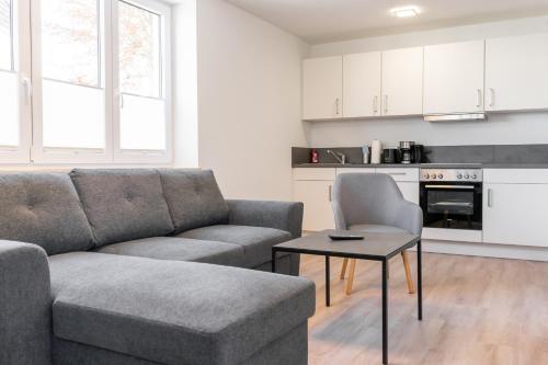a living room with a couch and a table at Landschaftliches Haus in Tönning
