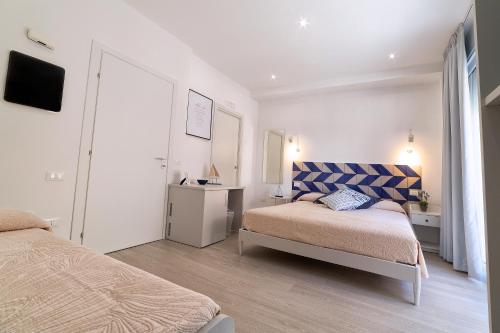a small bedroom with two beds and a television at Lo Scoglio della Formica B&B in Capo dʼOrlando