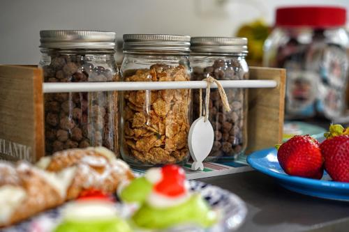 a group of jars filled with nuts and fruit at Lo Scoglio della Formica B&B in Capo dʼOrlando