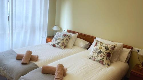 two beds with stuffed animals on them in a bedroom at Sopelana pueblo con Garaje & Wifi in Sopelana
