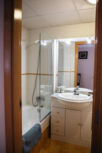 a bathroom with a sink and a shower at Townhouse with terraces and communal pool in Gandía