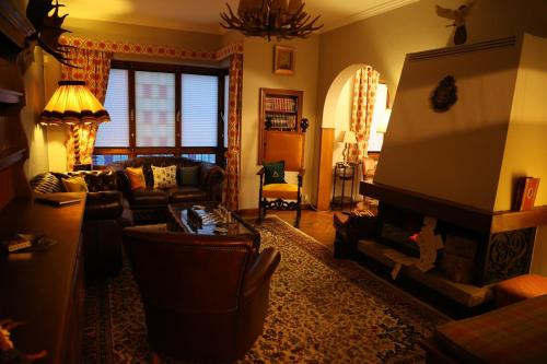 a living room with a couch and a fireplace at Potter's Place by Ardenne Places in Theux