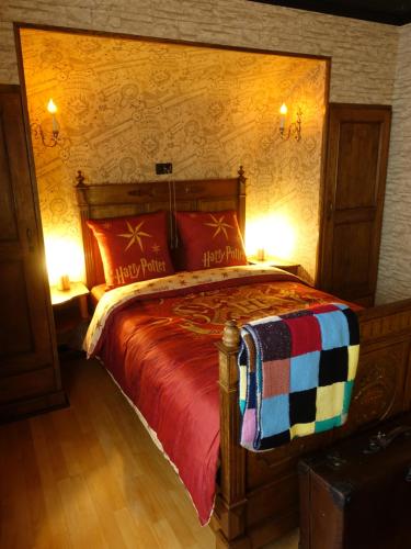 a bedroom with a large wooden bed with red pillows at Potter's Place by Ardenne Places in Theux