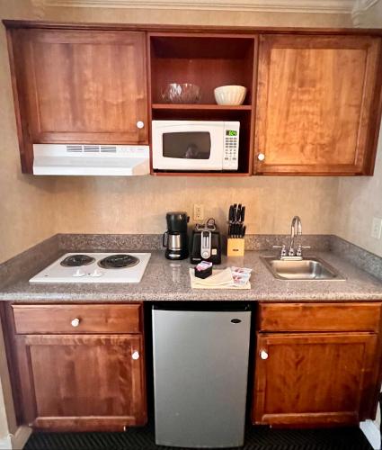 a kitchen with a sink and a microwave at Yosemite View Lodge in El Portal