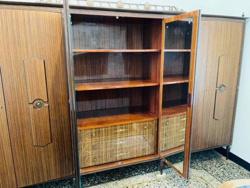 an empty wooden book shelf in a room at MH Genova in Genoa