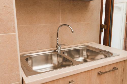a stainless steel sink in a counter in a kitchen at La Casetta Antica in Noci