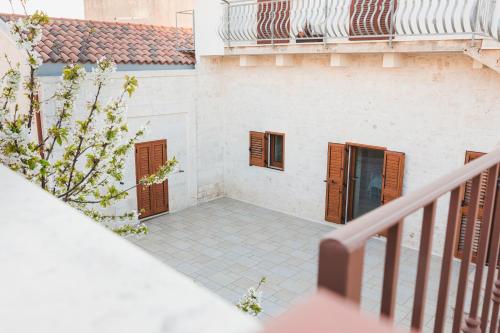 a view from the balcony of a building with brown shutters at La Casetta Antica in Noci