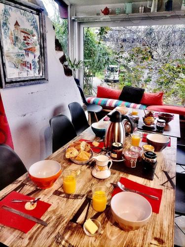 a wooden table with food on top of it at Studio le moulin de Pascale in Espelette